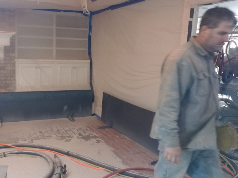 Soda blasting process removing varnish from antique wooden bar
